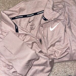 Nike Running Dri-FIT half-zip long sleeve top in pale pink